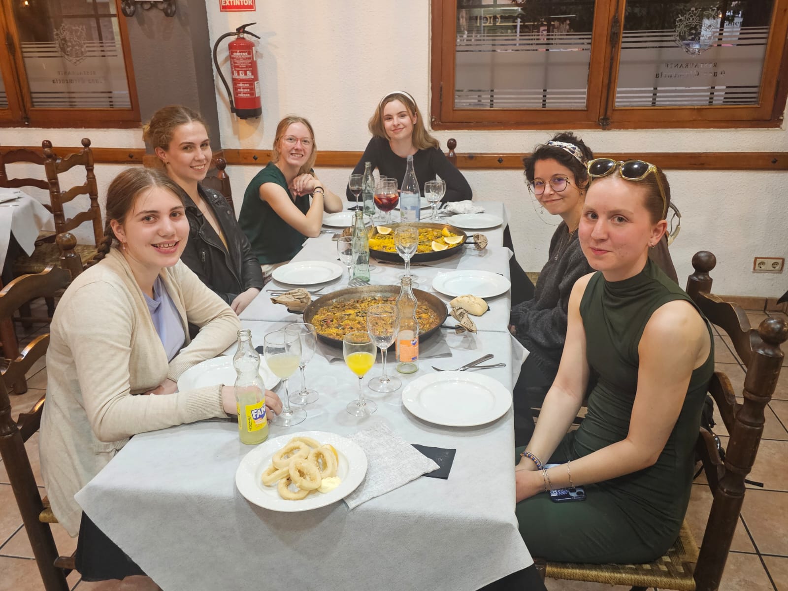 Photo of students enjoying traditional Spanish cuisine in Valencia.