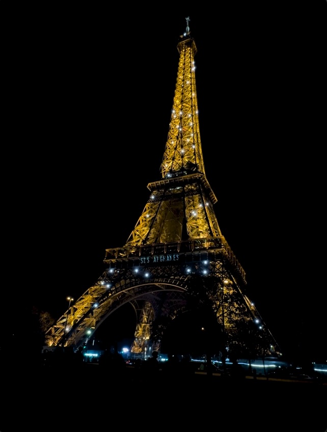 The Eiffel Tower lit up at nighttime.
