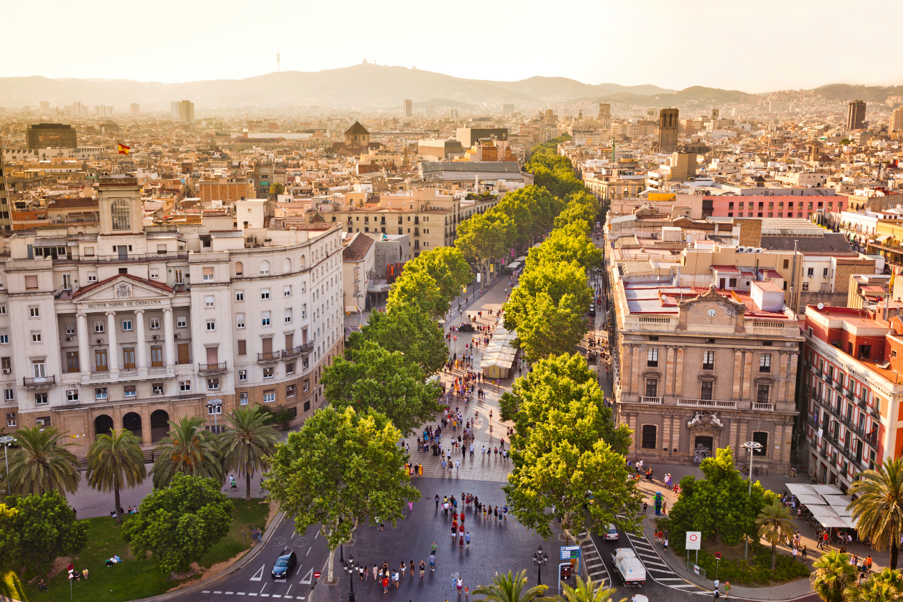 An aerial view of the southern end of La Rambla in Barcelona: a tree-lined pedestrian thoroughfare with grand buildings on either side