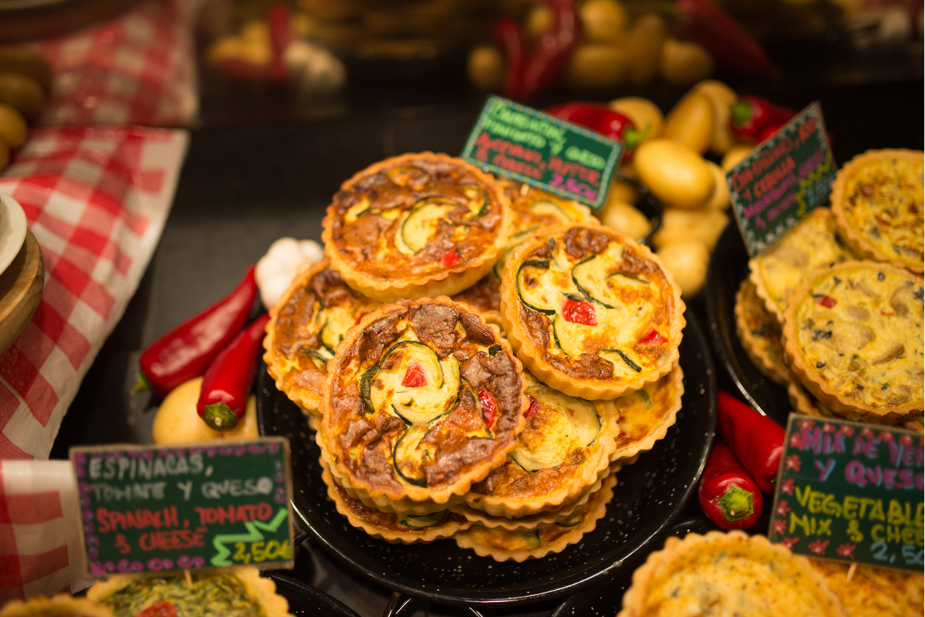 A stack of onion tarts on a dark tablecloth