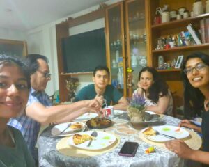 Homestay trip photo, students eating dinner with the host family.