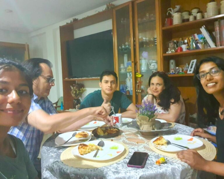 Homestay trip photo, students eating dinner with the host family.