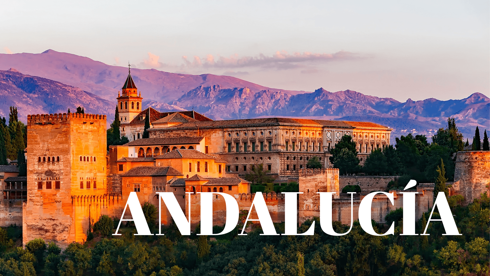 The Alhambra fortress in the evening sunshine, with the Sierra Nevada mountains rising dramatically in the background