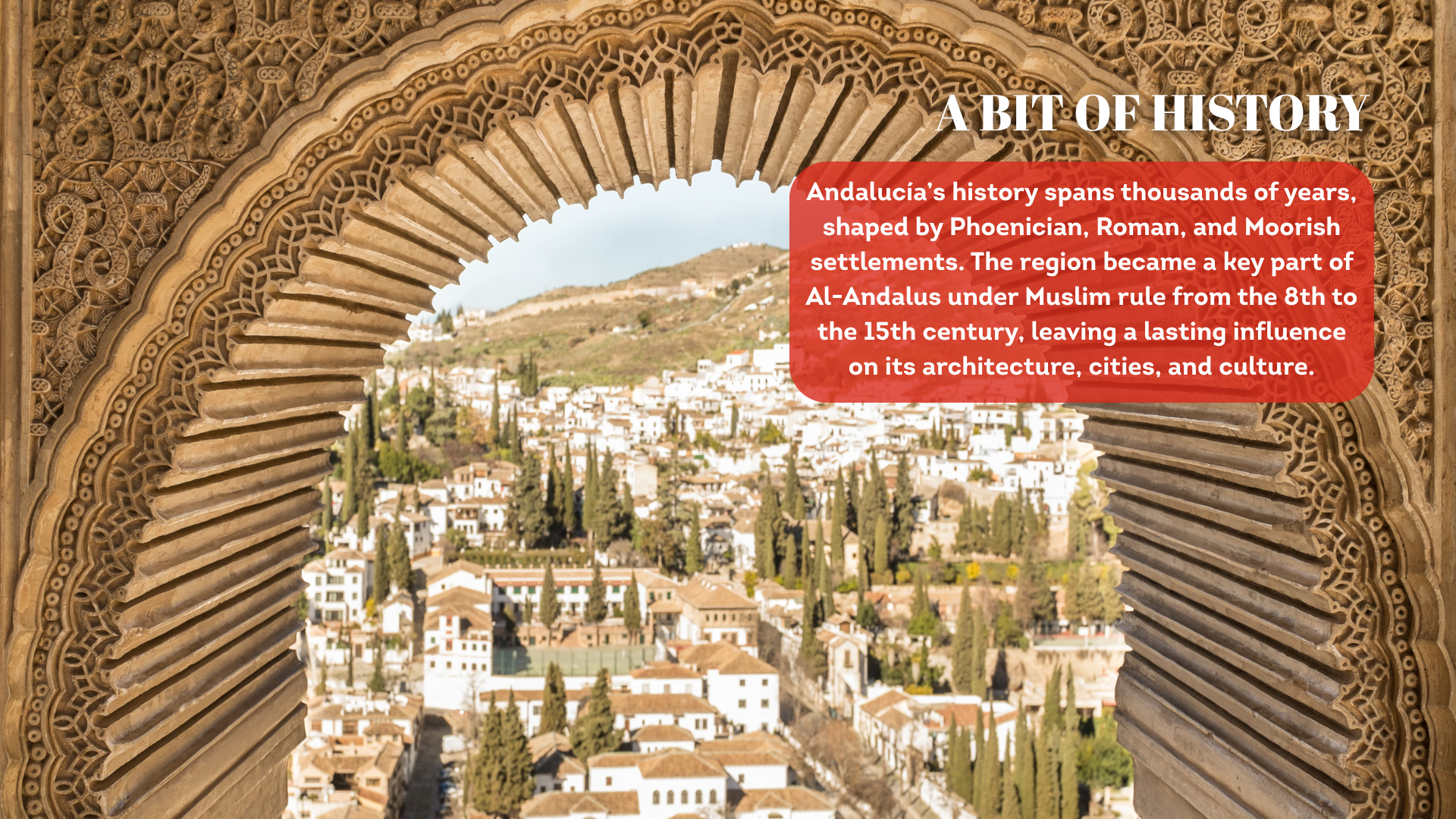 A view of a town seen through an elaborately carved moorish archway