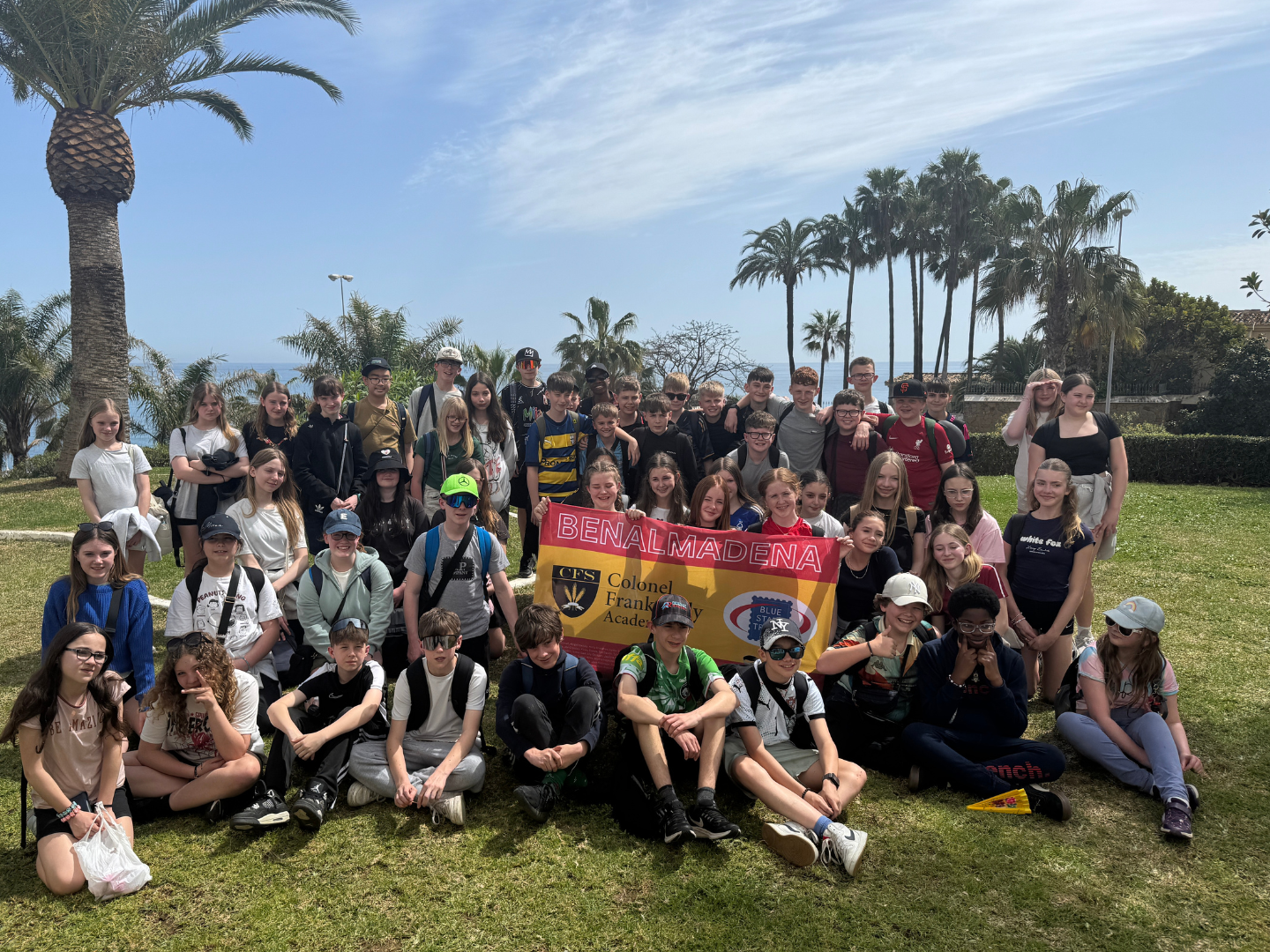 A group of students on a school trip to Andalusia in a group photo in a park