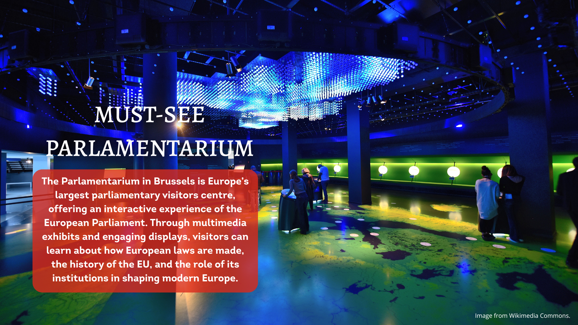 A high-tech interior with light coming from sources on the ceiling and walls. People are looking at screens.