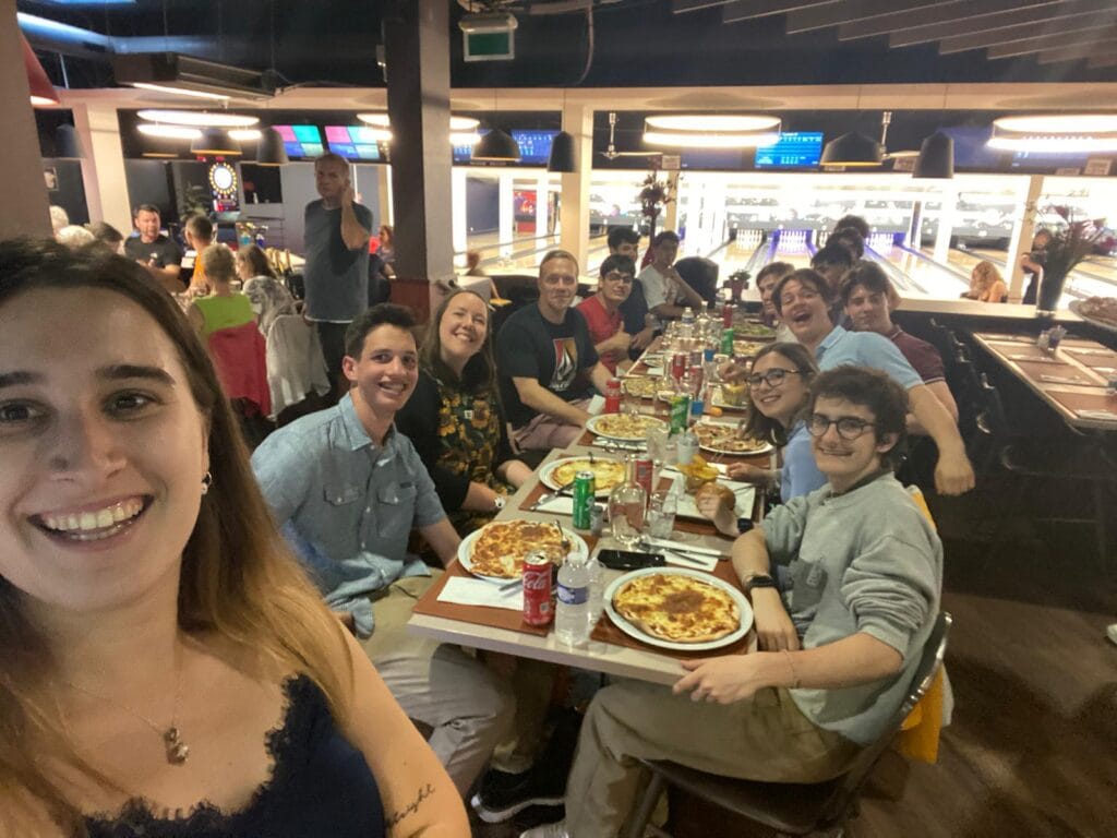 Students enjoy a pizza meal on a trip abroad.