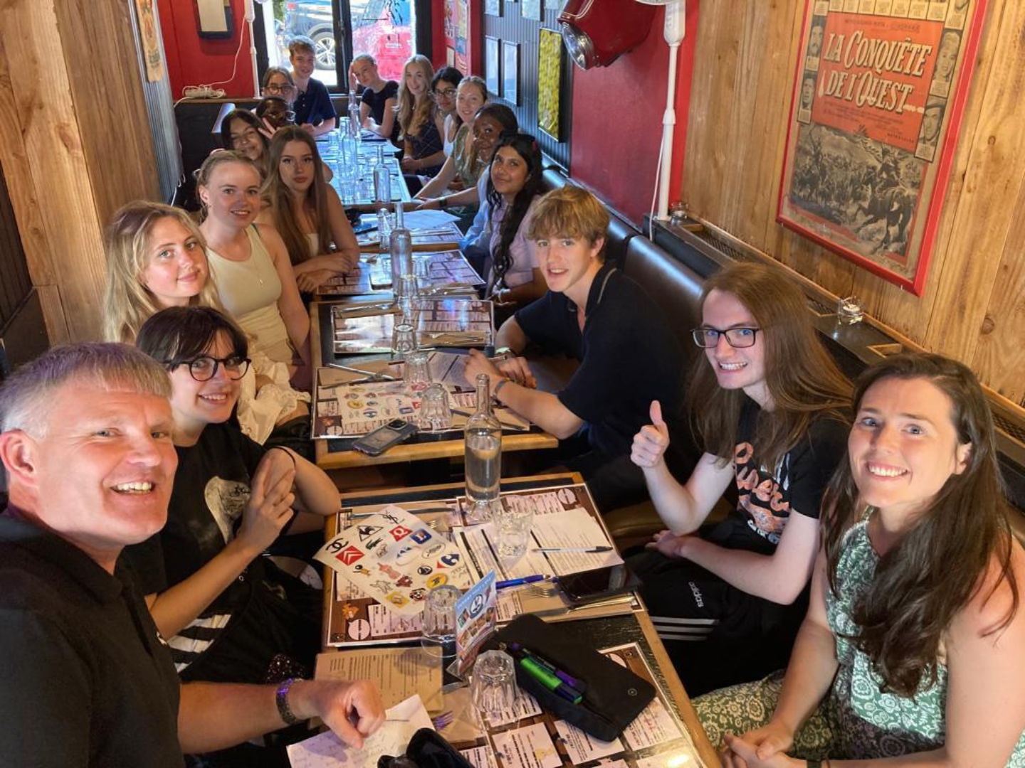 A group of students enjoy a meal on a school trip to Rouen with Blue Stamp Travel