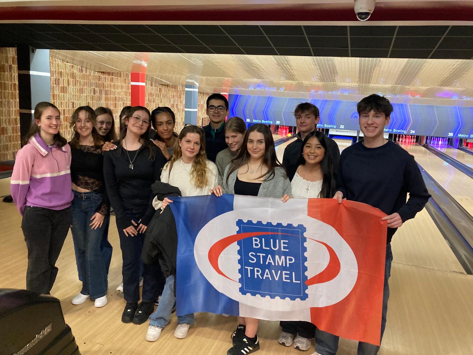 A group of Work Experience students hold a Blue Stamp Travel banner
