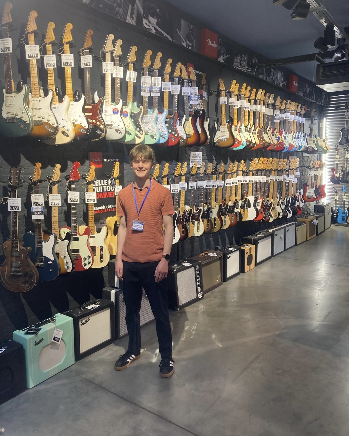 A Work Experience student stands in a guitar shop in France