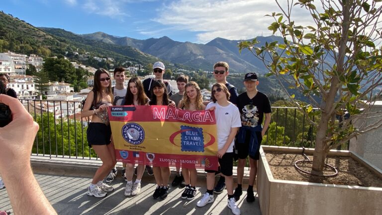 Students with flag on the Nottingham Consortium trip to Malaga.