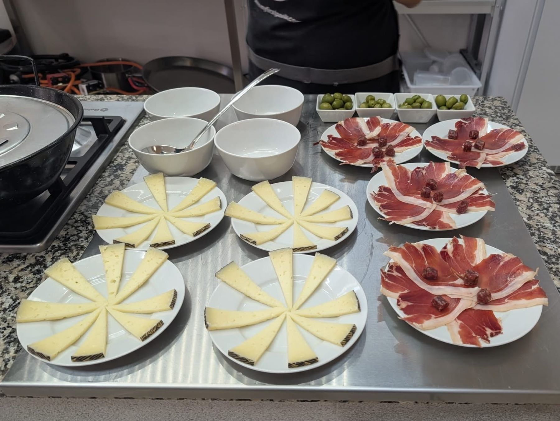 Traditional Spanish tapas, prepared by chefs before the paella-making workshop.
