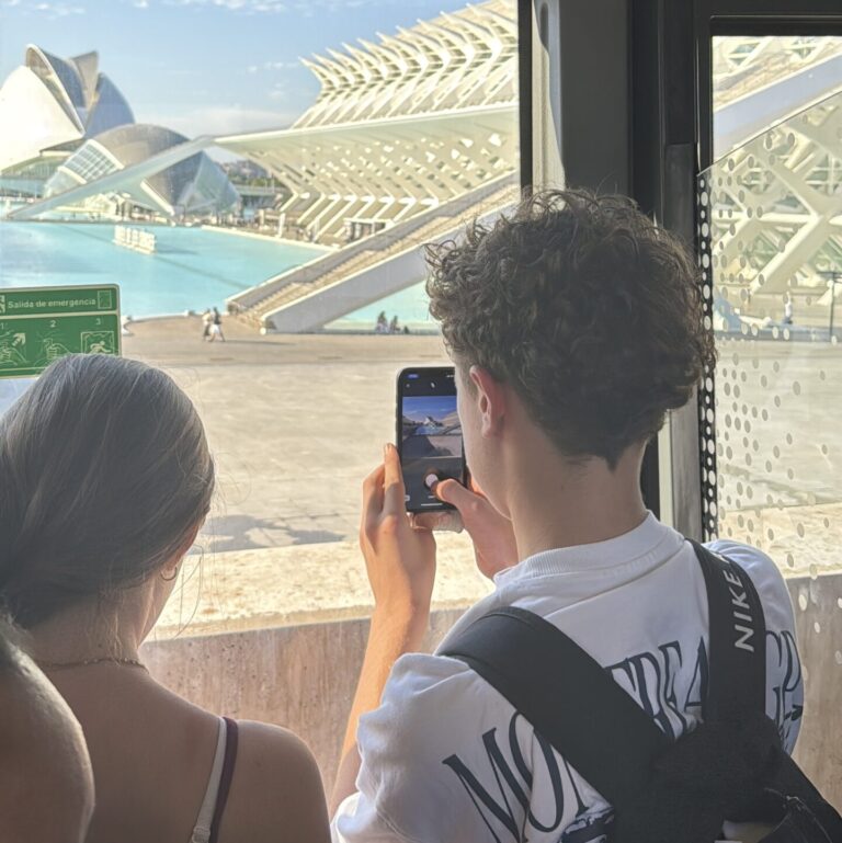 Student photographing the the City of Arts and Sciences on a mobile phone.