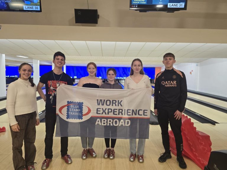 Students in Lille holding a Work Experience Abroad flag.