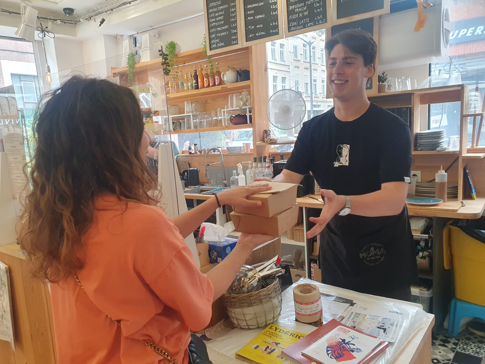 Photo demonstrating how language learning helps a student talk to a cafe assistant abroad.