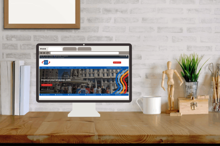 Stock image of the Blue Stamp Travel website on a computer screen on a desk.