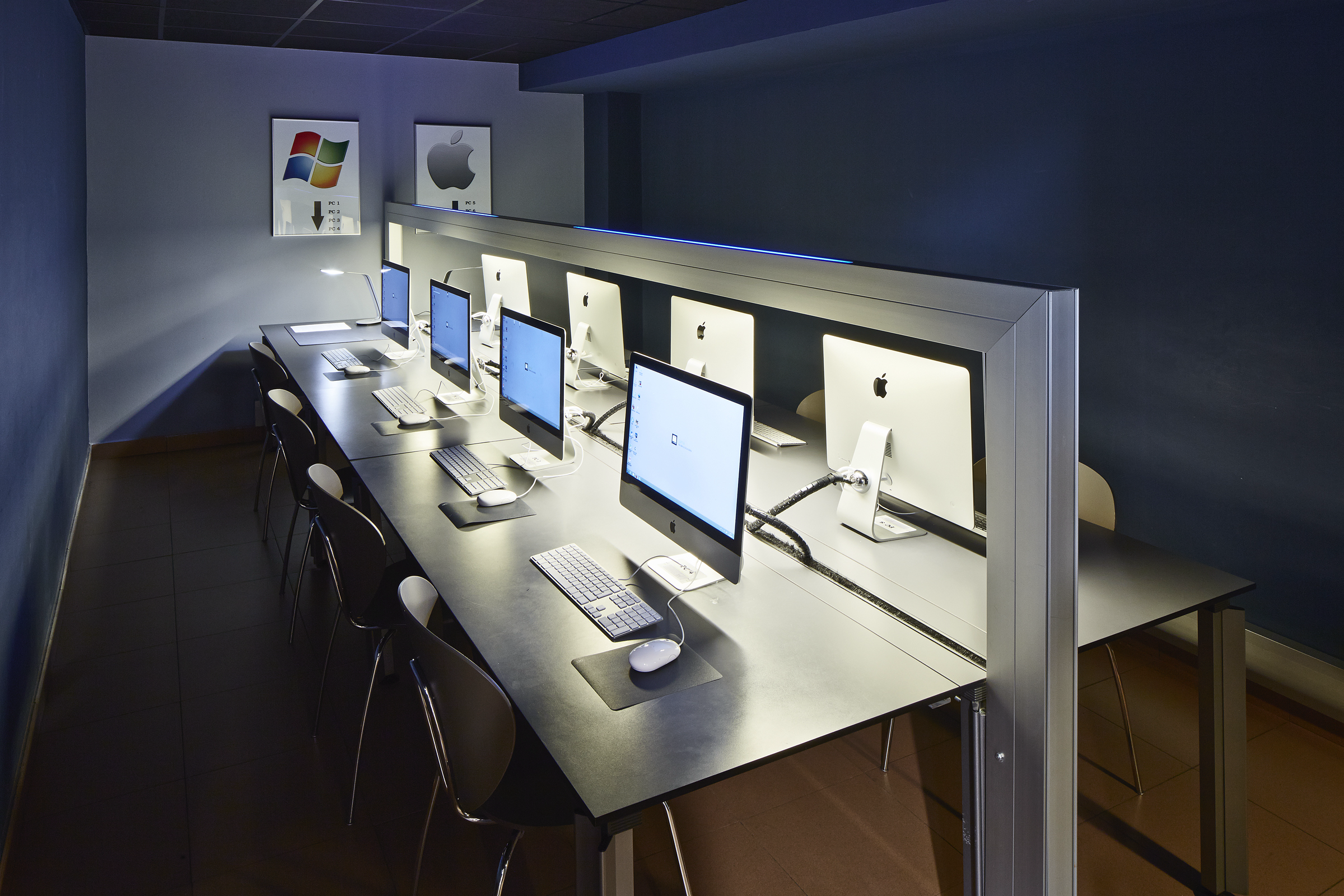 A computer room with 8 screens