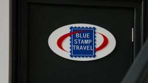 Blue Stamp Travel office sign.