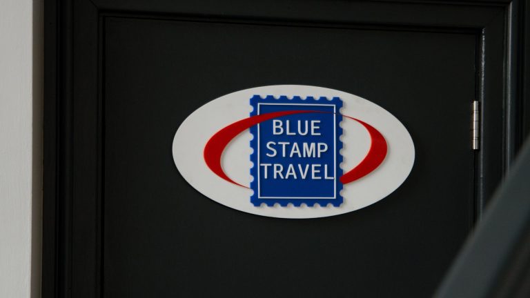 Blue Stamp Travel office sign.